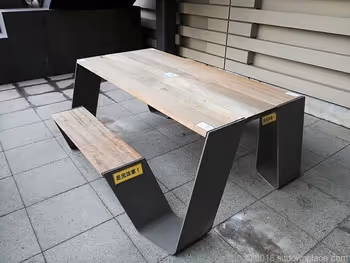 Table seats under the pedestrian deck of Oosaki West Exit Park