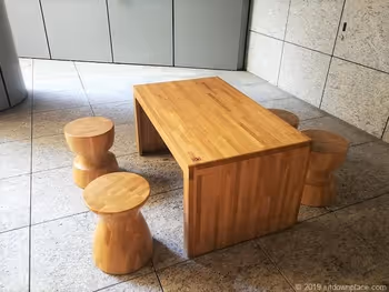 Wooden 4-person table seats at the KITTE Nagoya B1F Outdoor Stairway Entrance
