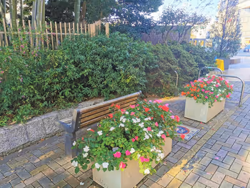 Benches and flowerbeds in the resting area of the Fureai Sidewalk at Komae Station North Exit